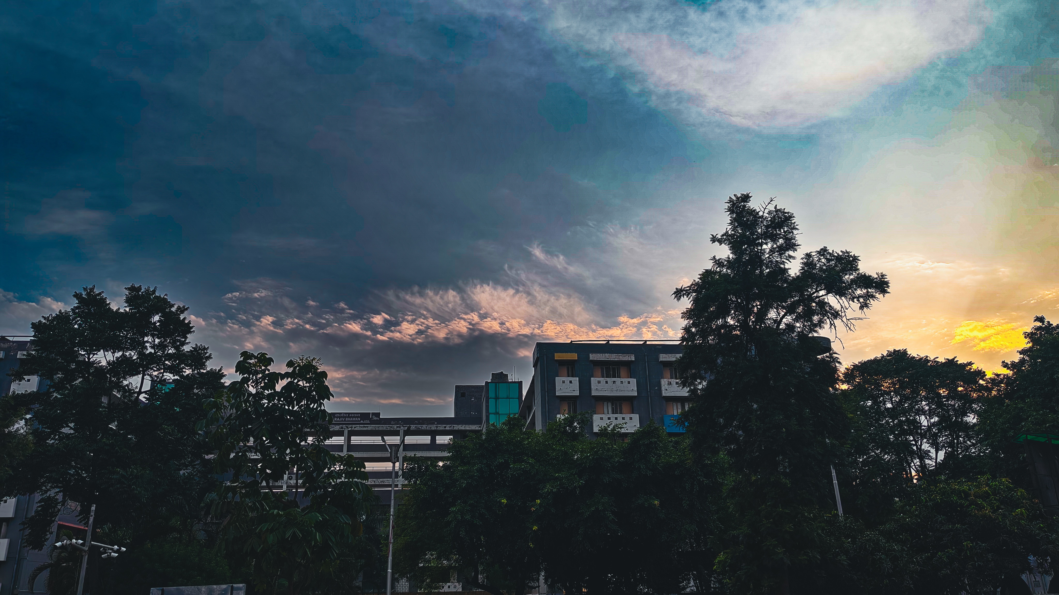 Towering white clouds over urban buildings captured by Clixzsera